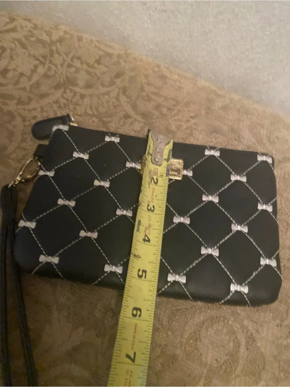 Betsey Johnson Black Quilted Bow-Print Wristlet with Gold Plaque